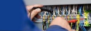 electrician testing a fuse box