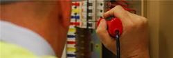 electrician testing a fuse board